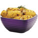 A Vollrath passion purple metal bowl filled with corn on the cob.