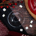 A Dart clear plastic bowl lid with a hole over a glass of wine with a red and white object inside.