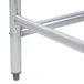 An Advance Tabco stainless steel work table with an open metal frame.