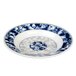 A close-up of a blue and white Thunder Group Blue Dragon melamine soup plate with a dragon design.