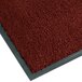 A crimson Notrax carpet entrance mat with a grey border.