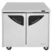 A white Turbo Air undercounter refrigerator with black doors and drawers.