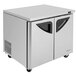 A Turbo Air stainless steel undercounter refrigerator with black handles on two doors.