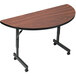 A Correll walnut half round table with wheels.