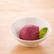 A white Arcoroc Ludico porcelain bowl filled with red ice cream.