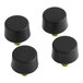 A group of black plastic caps with yellow screws.