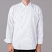 A man wearing a white Mercer Culinary long sleeve chef jacket with knot buttons.