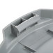 A close-up of a grey Continental Huskee trash can lid with holes.