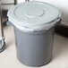 a grey garbage can with a plastic bag