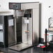 A Bunn 3 gallon iced tea brewer on a counter.