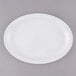 A white Thunder Group Nustone melamine oval platter with a narrow white rim.