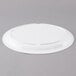 A white Thunder Group Nustone melamine oval platter on a gray surface.