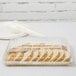 A Fineline ivory plastic rectangular tray with sliced bread in it.