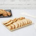 A tray of sliced bread on a table.