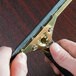 A person using an Unger brass channel to clean a window.