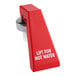 A red faucet handle for hot water with white text reading "Lift" on a red button.