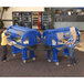 Two women putting food into a blue Cambro food cart.