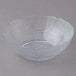 A clear plastic bowl with a curved edge.