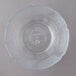 A clear plastic bowl with a scalloped edge.