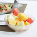 A Carlisle Petal Mist bowl of fruit with a fork.