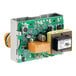A green circuit board with a black and yellow electronic device.