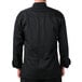 A man wearing a Mercer Culinary black chef jacket with cloth knot buttons.
