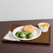 A Cambro dietary tray with a sandwich, broccoli, and bread.