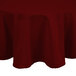 A burgundy Intedge round tablecloth on a table.