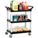 A black Vollrath utility cart with three shelves holding food items.