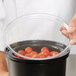 a group of tomatoes in a bowl