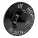 A black Vulcan thermostat knob with white text on it.