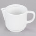 An Arcoroc white porcelain teapot with a handle.