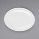 A white oval platter with a white rim on a gray surface.