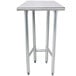 A stainless steel Advance Tabco work table with an open base.