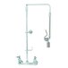 A chrome T&S pre-rinse faucet with a silver swivel arm and hose.