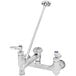 A silver and chrome T&S wall mount mop sink faucet with two handles and a long spout.