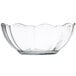 An Arcoroc clear glass bowl with a scalloped edge.