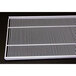 A white metal grid with a narrow gap on a black surface.