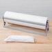 A Bulman paper cutter holding a roll of paper on a table.