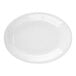 A Tuxton Concentrix white oval china coupe platter with a white background.