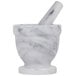 a white marble mortar and pestle