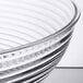 A Cambro clear Camwear round bowl with ribbed design.