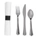 A set including a rolled white linen-feel napkin with a black band, a plastic fork, knife, and spoon with a stainless steel look.
