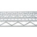 A close-up of a Metro Super Erecta chrome wire shelf with a grid top.