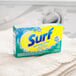 A box of Surf Sparkling Ocean Powder Laundry Detergent on a counter.