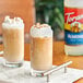 Two glasses of coffee with Torani Almond Flavoring Syrup and whipped cream.