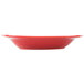 A close up of a red square pasta bowl with a white background.