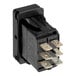 A black electrical rocker switch with six metal prongs, designed for use in appliances or equipment.