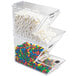 A clear plastic Cal-Mil topping dispenser filled with candy on a counter.