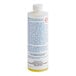 A close-up of a white Manitowoc Ice cleaner bottle with blue and white labels.